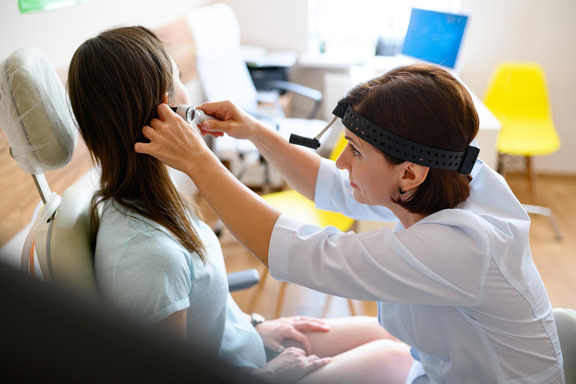 female-ent-doctor-and-patient-in-office-ear-exam